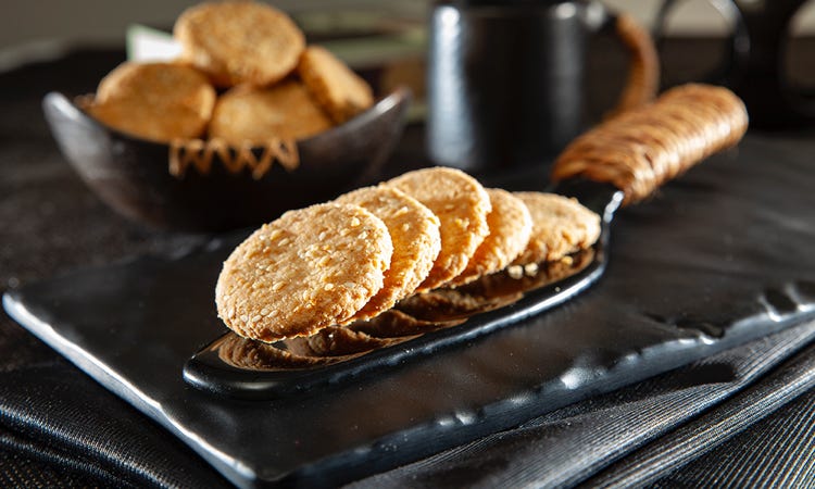 This stunning photograph captures the beauty of freshly baked biscuits and cookies. The vibrant colors and textures of the sweets are illuminated by the warm lighting, creating a cozy and inviting atmosphere. The light catches the golden brown edges of the cookies and casts a beautiful shadow on the background, adding an extra layer of depth to the image. The arrangement of the cookies also adds a sense of artistry and craftsmanship, making this a truly special photograph. Biscuits & Cookies Photography for banners, printing, e commerce concepts