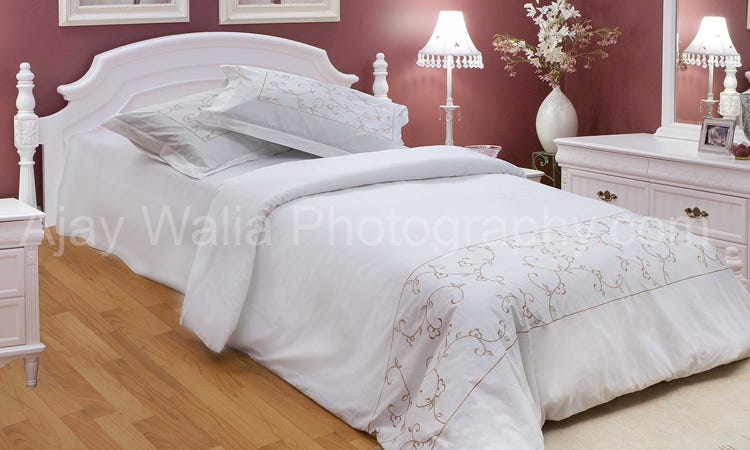  This photo is a simple yet stunning shot of a bed sheet. The white sheet is stretched out over the bed with crisp creases and a few wrinkles in the fabric. The sheet is illuminated by natural light streaming in from a nearby window, creating a beautiful composition of light and shadow. The sheet's texture is highlighted by the light, creating a dreamy and serene atmosphere. This photo is a great example of how a simple object can be transformed into a captivating image., Bed Sheet Photography in Delhi by Ajay Walia